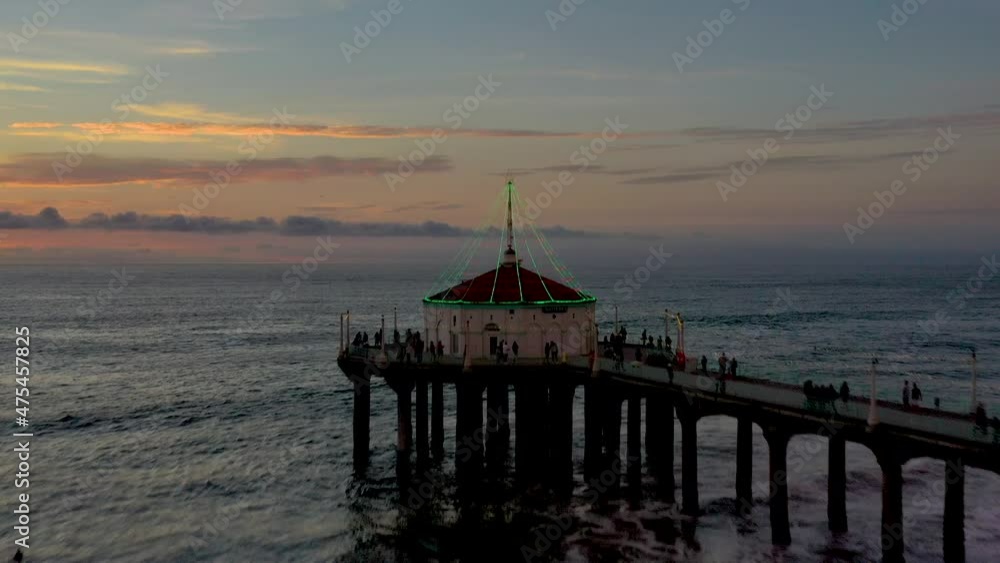 Aerial shot of Manhattan Beach, California, USA. Drone shot of over the Pier with the Roundhouse Aquarium at dusk. Aerial shot of Manhattan Beach, California, USA. Drone shot of over the Pier with the Roundhouse Aquarium at dusk.