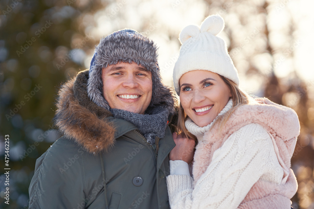 Couple having fun in winter scenery and snow