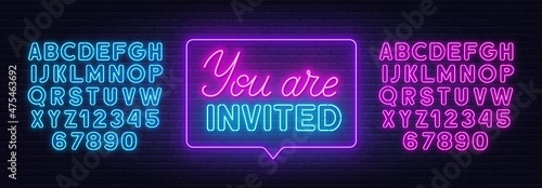 You are invited neon sign on brick wall background.