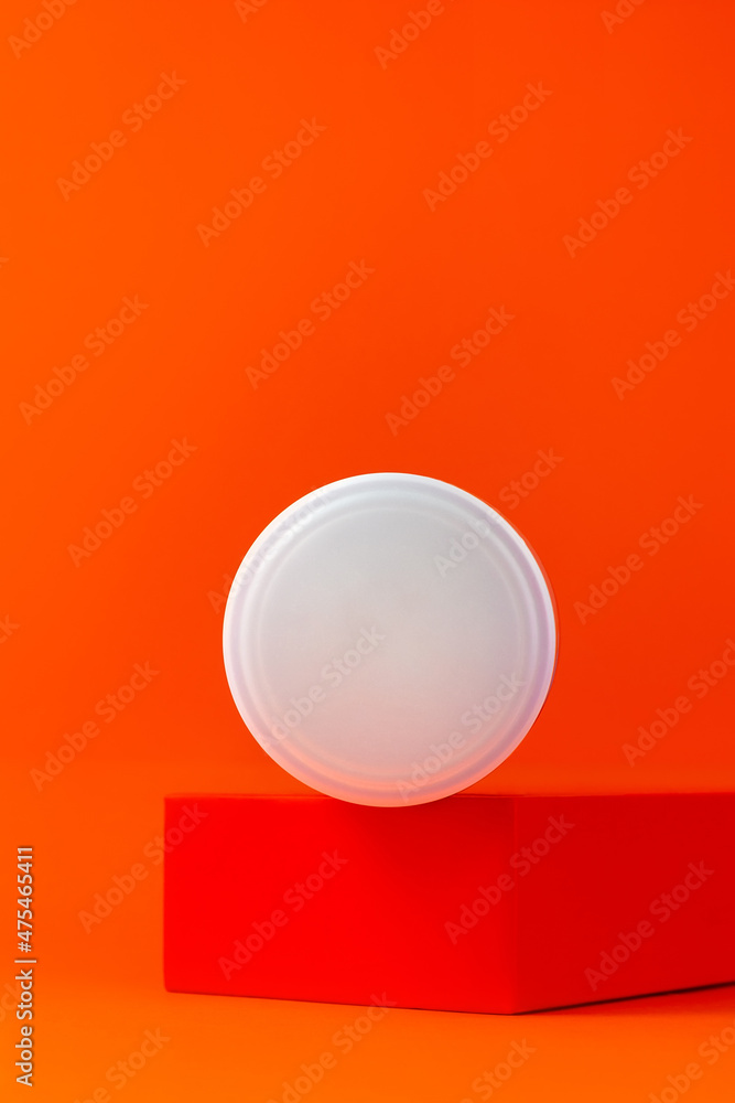 White blank cream jar mockup on geometrical podium orange background. Skincare product unbranded plastic package Natural eco-friendly anti aging skin cosmetic moisturizer SPA Wellness facial hydration White blank cream jar mockup on geometrical podium orange background. Skincare product unbranded plastic package Natural eco-friendly anti aging skin cosmetic moisturizer SPA Wellness facial hydration
