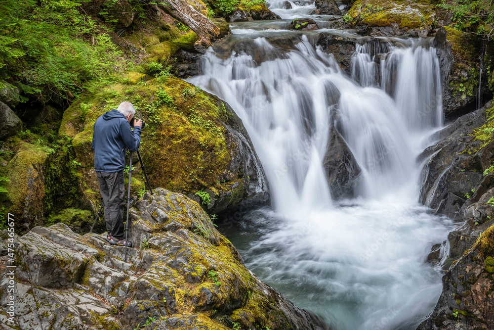 USA, Washington State, Mount Rainier National Park. Photographer and waterfall. USA, Washington State, Mount Rainier National Park. Photographer and waterfall.