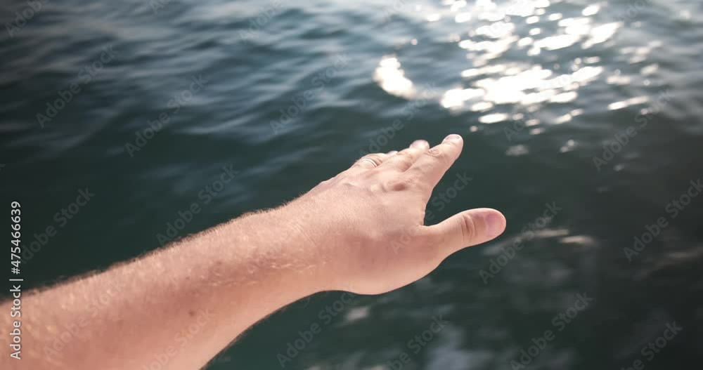 man's hand hovers above the sea surface man's hand hovers above the sea surface