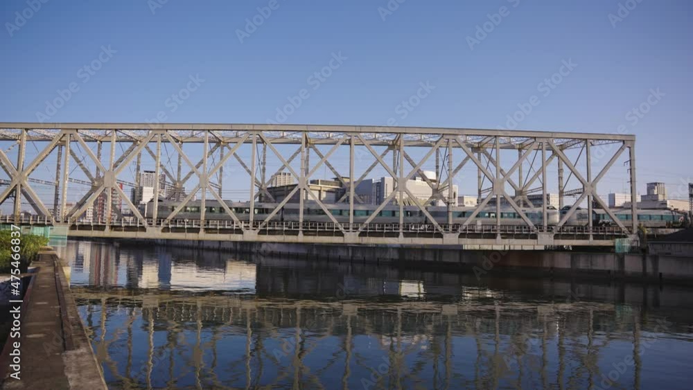 Train crossing Iron Bridge and River in Taisho, Osaka, Japan Train crossing Iron Bridge and River in Taisho, Osaka, Japan