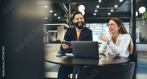Tableau sur toile Two happy young businesspeople working together