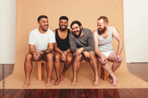 Vászonkép Four men laughing together in a studio