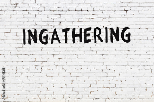 White wall with black paint inscription ingathering on it