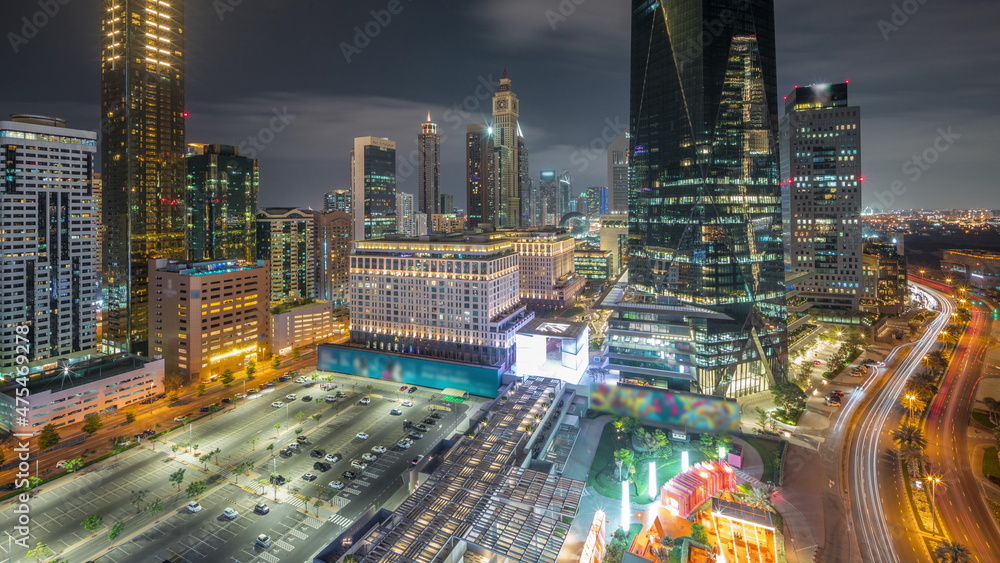 Fototapeta premium Dubai International Financial district aerial all night timelapse. Panoramic view of business and financial office towers.
