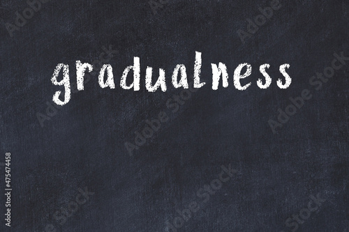 Inscription gradualness painted on white brick wall photo