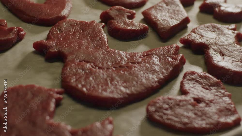 Cookie dough with red coloring shape out as a small duck and a heart. close up pan Cookie dough with red coloring shape out as a small duck and a heart. close up pan