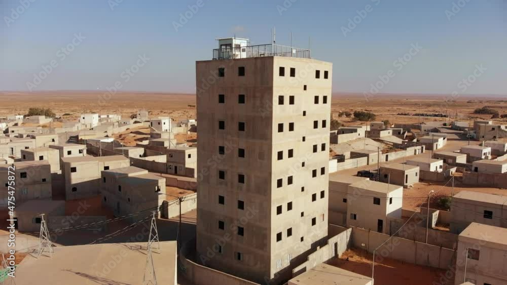 aerial view of big building in an old empty city at palestine near gaza in the desert while camera moves forward revealing the rest of the city. aerial view of big building in an old empty city at palestine near gaza in the desert while camera moves forward revealing the rest of the city.