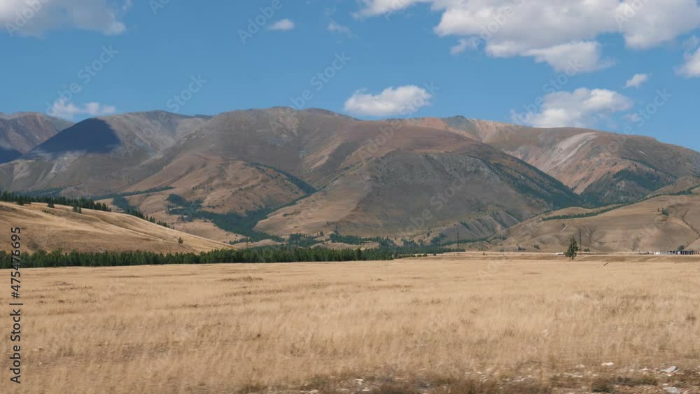 Side View From Driving Car On Arid Prairie In Mountainous Area With Hills Side View From Driving Car On Arid Prairie In Mountainous Area With Hills