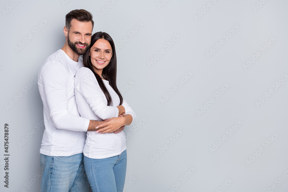 Profile photo of cute millennial couple hug near ad wear white shirt isolated on grey color background Profile photo of cute millennial couple hug near ad wear white shirt isolated on grey color background