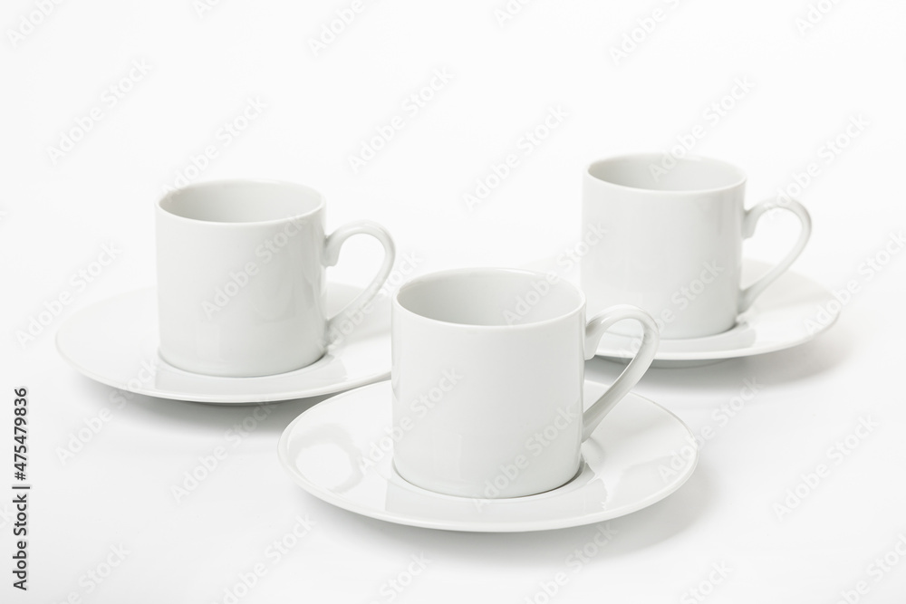 White porcelain cup and saucer for cappuccino and coffee isolated on a white background White porcelain cup and saucer for cappuccino and coffee isolated on a white background