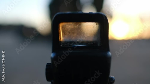macro close-up of a rifle holographic scope with scratches photo