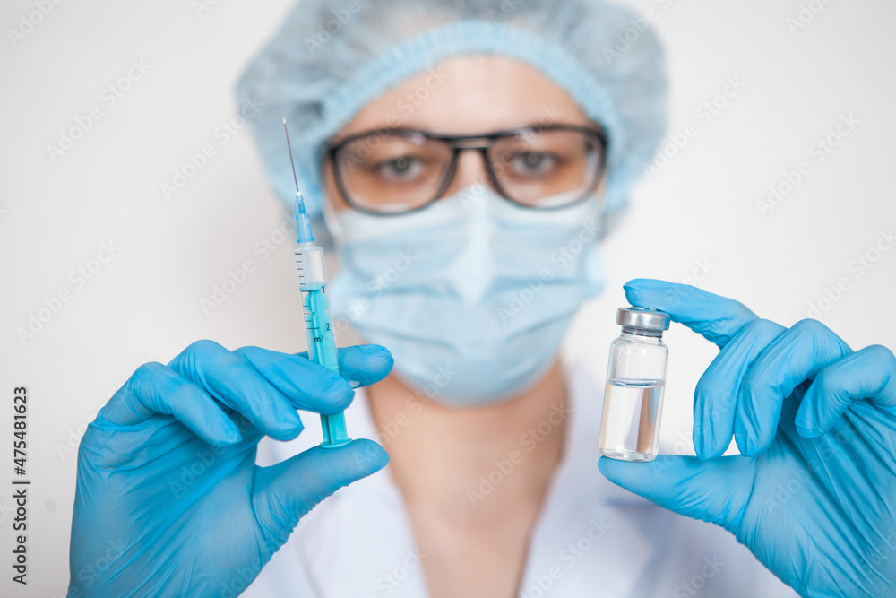 Doctor, nurse, scientist hand in blue gloves holding flu, measles, coronavirus, covid-19 vaccine. Doctor, nurse, scientist hand in blue gloves holding flu, measles, coronavirus, covid-19 vaccine.