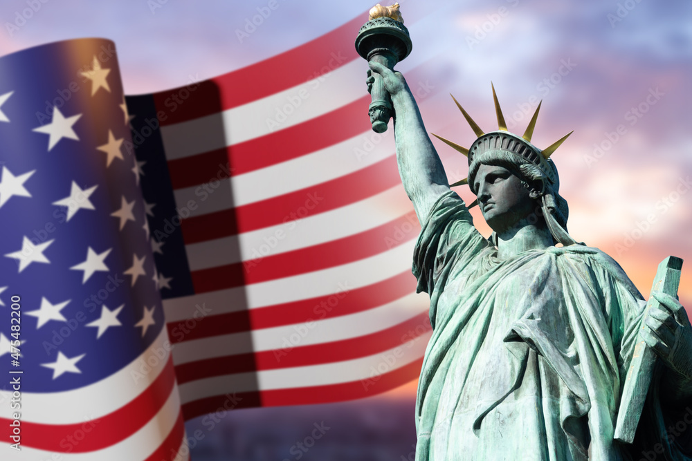 Obraz premium Statue of Liberty USA. Liberty Enlightening World in New York. Waving flag of America on sunset background. Monument dedicated to independence of America. Symbols of United States of America.