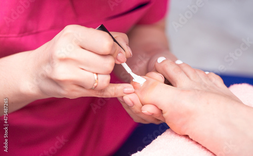 Pedicure care for your feet makes a professional master in the salon Spa procedures, relaxation at a cosmetologist.