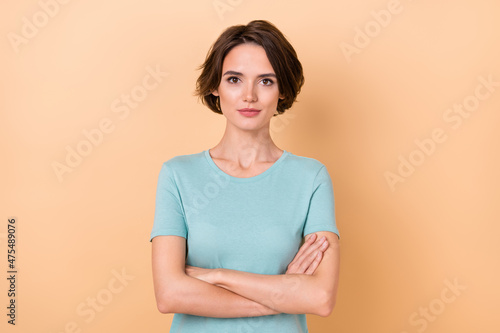 Photo of young pretty lady folded hands concentrated clever crossed hands isolated over beige color background