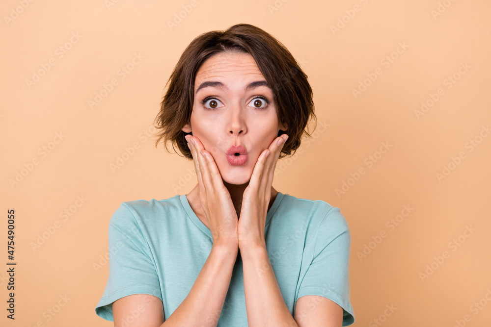Photo of young woman impressed face reaction omg arms touch cheeks isolated over beige color background Photo of young woman impressed face reaction omg arms touch cheeks isolated over beige color background