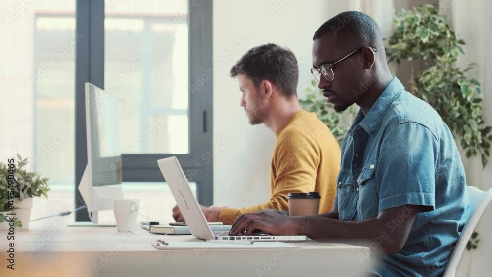 Video of two concentrated graphic designer working with computer in modern startup office. Video of two concentrated graphic designer working with computer in modern startup office.