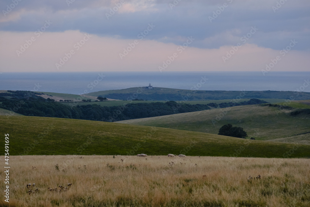 Beachy Head on South Downs, East Sussex with Belle Tout Lighthouse and the English Channel in the distance.