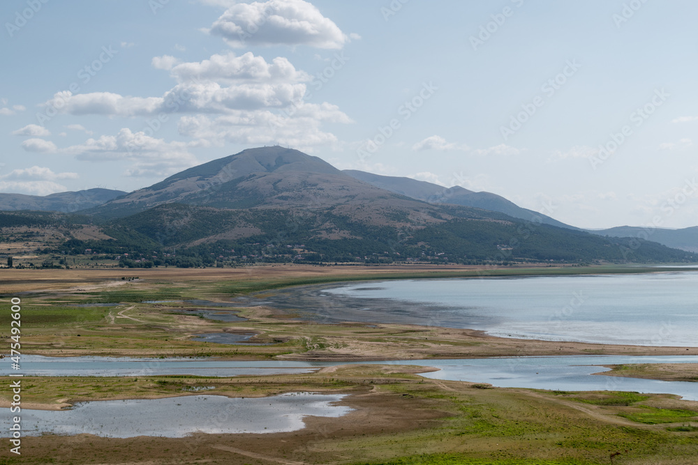 The landscape of Busko Lake in summer with low water levels and mountains in the background