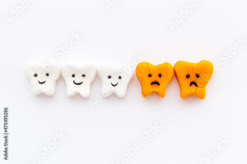 Teeth models with caries or plaque on gums. Oral health concept