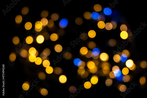 Perfect bokeh for a festive New Year and Christmas background. Defocused abstract yellow and blue light circles