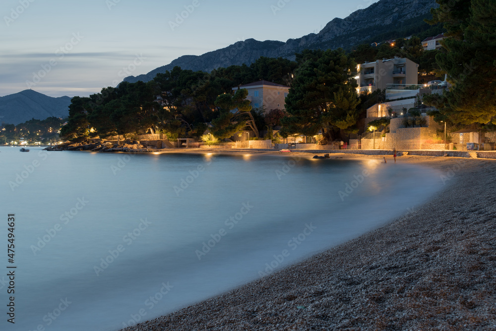 Tourist resort Brela on the Adriatic coast under the mountain Biokovo in Croatia, at dusk in summer