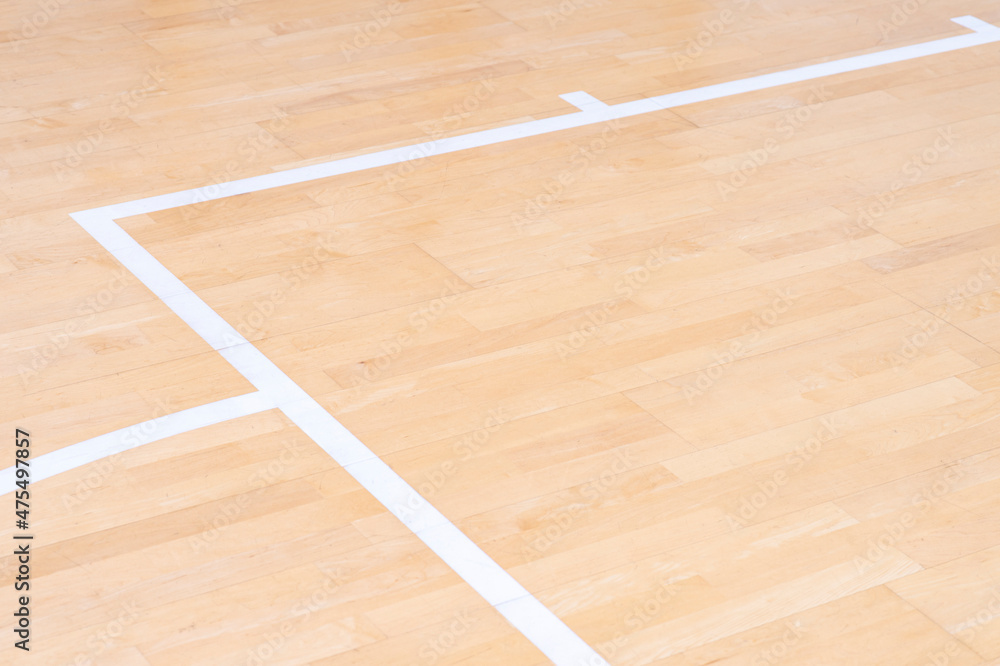 Wooden floor  basketball, badminton, futsal, handball, volleyball, football, soccer court. Wooden floor of sports hall with marking white lines on wooden floor indoor, gym court