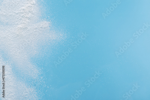 Blue background with artificial white snow. Winter motives. Christmas and New Year card design.