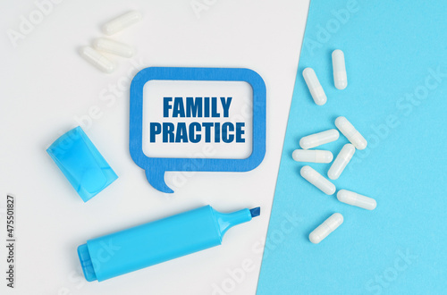On a white and blue table are pills, a marker and a blue plaque with the inscription - Family Practice