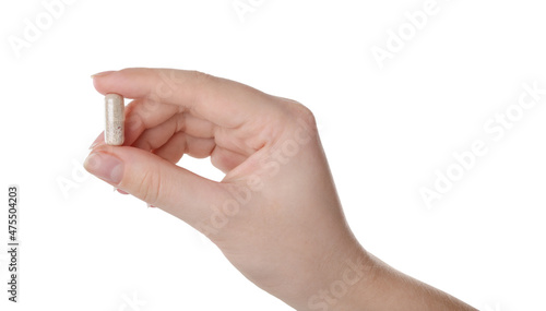 Woman holding gelatin capsule on white background, closeup