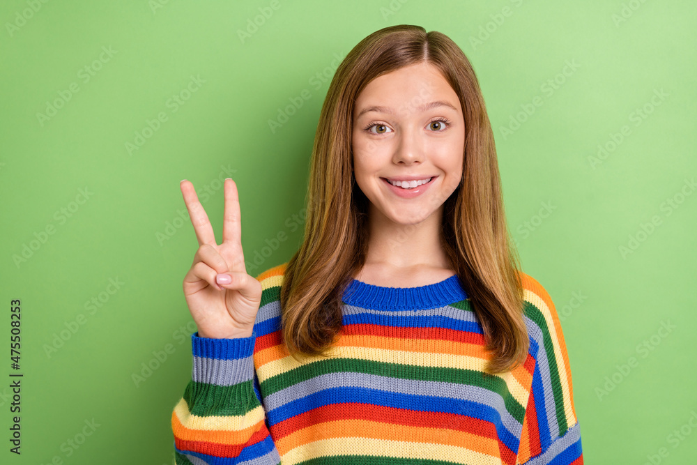Portrait of attractive funny tender girly cheerful girl showing v-sign good mood isolated over bright green color background Portrait of attractive funny tender girly cheerful girl showing v-sign good mood isolated over bright green color background
