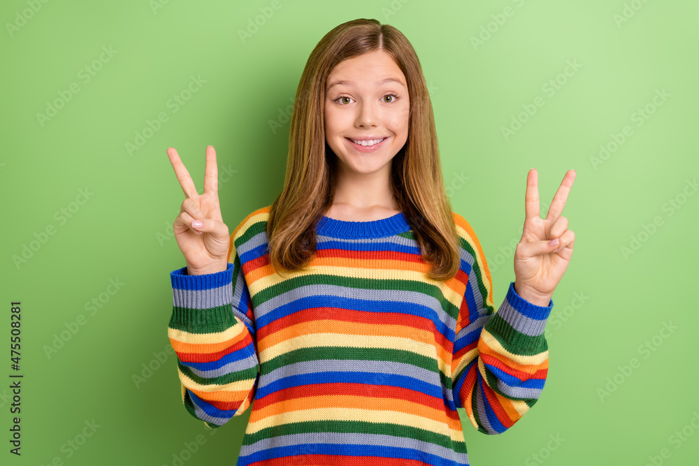 Portrait of attractive funny girly cheerful funky girl showing double v-sign party isolated over bright green color background Portrait of attractive funny girly cheerful funky girl showing double v-sign party isolated over bright green color background