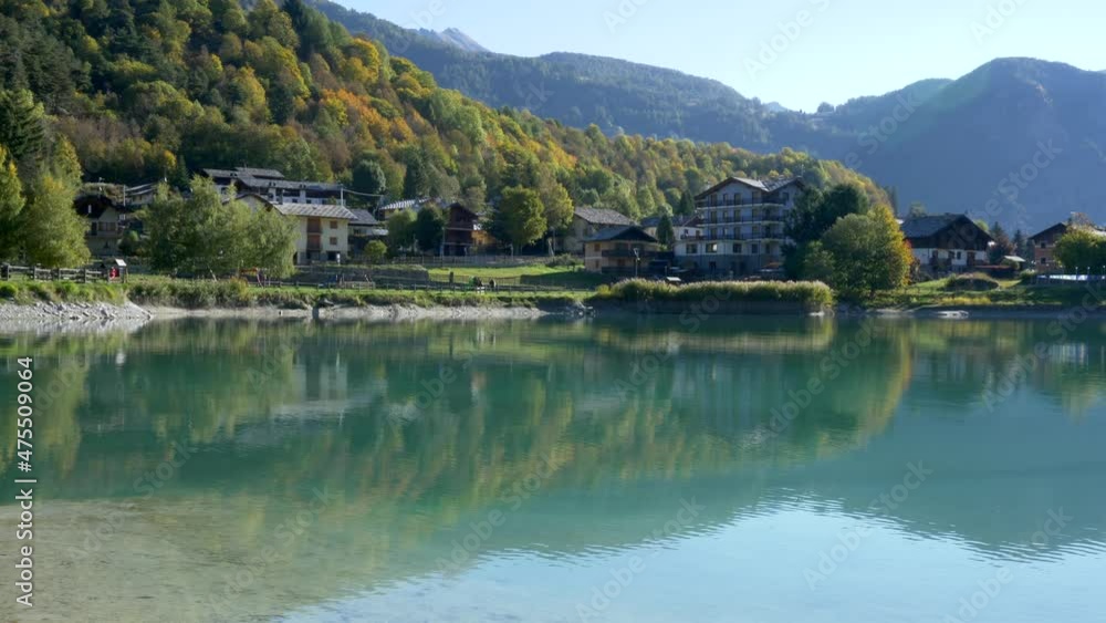 Beautiful landscape. Autumn trees reflected in the mountain lake. Panning 4K Beautiful landscape. Autumn trees reflected in the mountain lake. Panning 4K