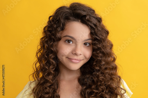 smiling kid with long curly hair and perfect skin, frizzy