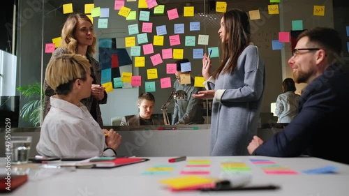 Colleagues And Clients Talking Strategy With Laptop And Tablet. In Creative Office Productive Coworkers Standing At The Table For Company Meeting. Teamwork And Scial Concepts photo