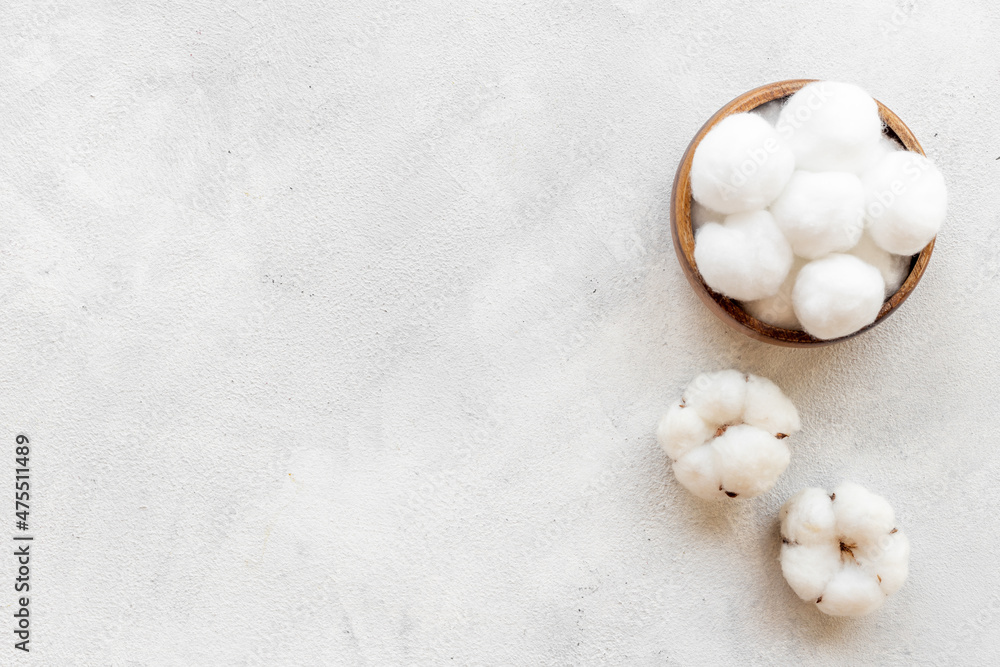 Cotton baby balls with cotton flowers, top view Cotton baby balls with cotton flowers, top view