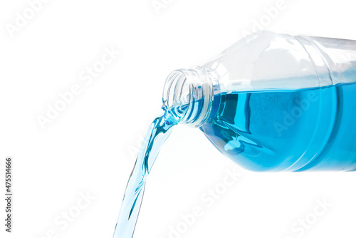 pouring of blue windshield washer fluid on white background