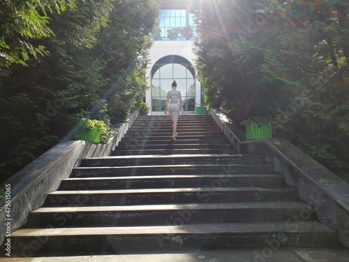 Fototapeta Naklejka Na Ścianę i Meble -  the girl goes up the stairs