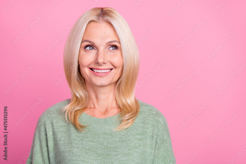 Photo of optimistic elder blond lady look empty space wear grey sweater isolated over pink color background Photo of optimistic elder blond lady look empty space wear grey sweater isolated over pink color background