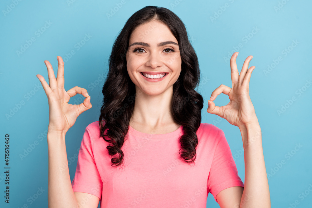 Photo of young pretty lady promoter show fingers okey symbol promo ads recommend isolated over blue color background Photo of young pretty lady promoter show fingers okey symbol promo ads recommend isolated over blue color background