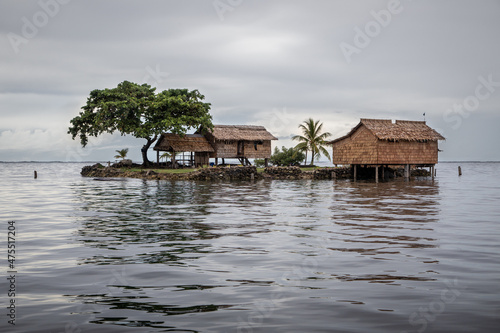 Traditional houses on a small artificial island in Lau Lagoon, Malatia Provence, Solomon Islands. photo