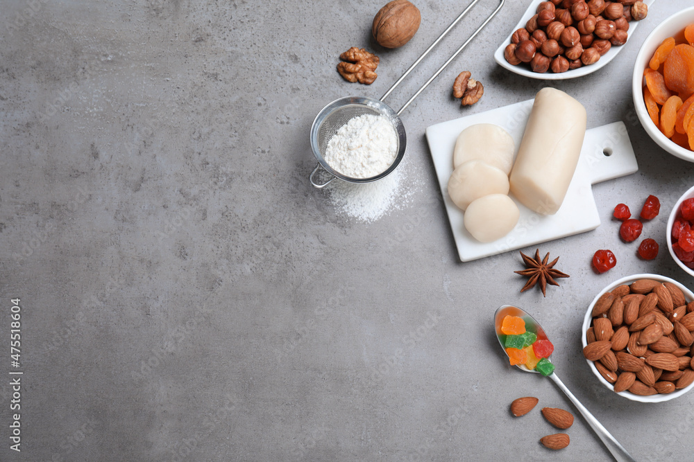 Ingredients for homemade Stollen on grey table, flat lay. Baking traditional German Christmas bread Ingredients for homemade Stollen on grey table, flat lay. Baking traditional German Christmas bread