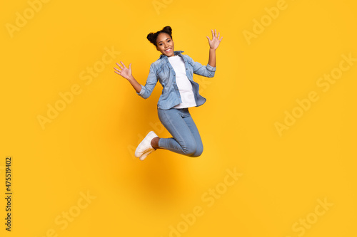 Full length profile side photo of young african lady good mood waving hands hello isolated over yellow color background