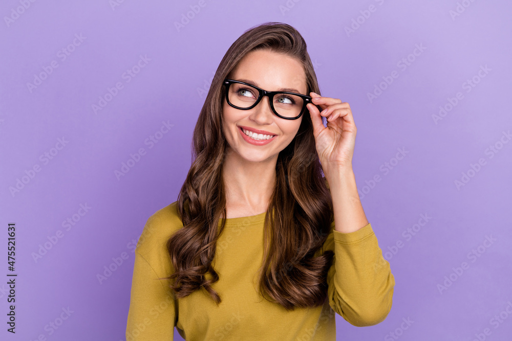 Portrait of cheerful minded person arm touch glasses look empty space isolated on purple color background