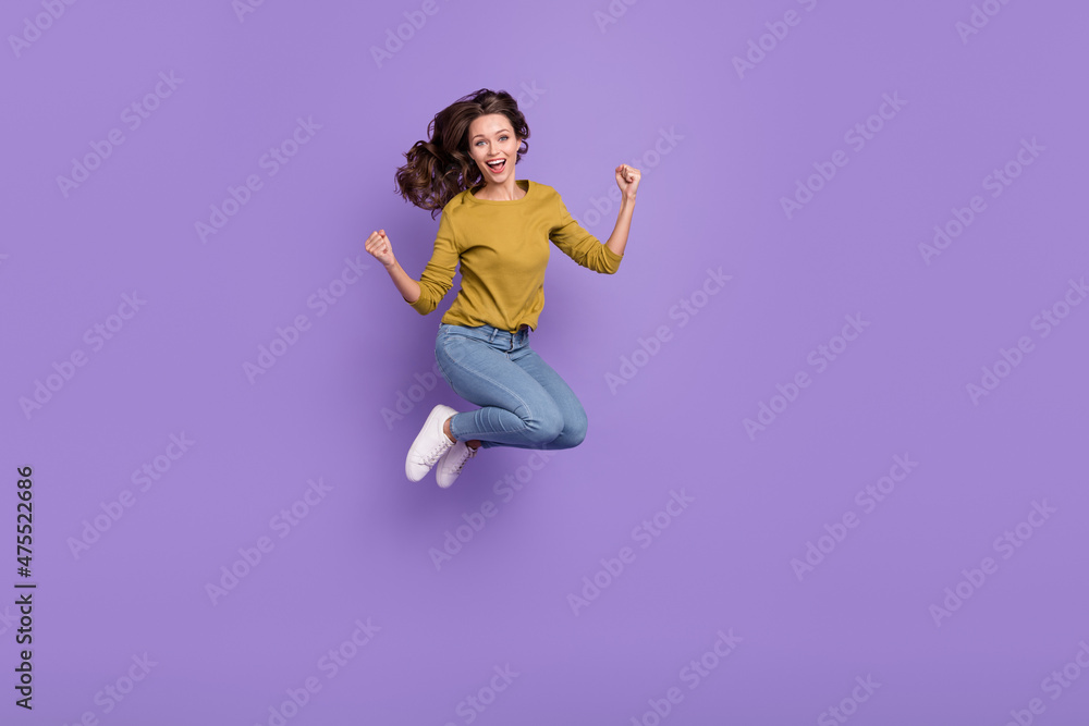 Full body portrait of energetic pretty lady raise fists shout yes celebrate triumph isolated on purple color background