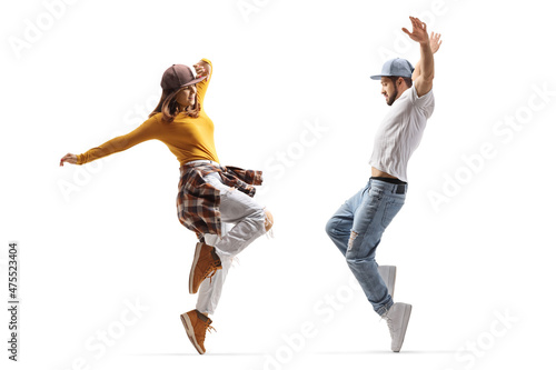 Full length profile shot of a guy and girl dancing hip hop