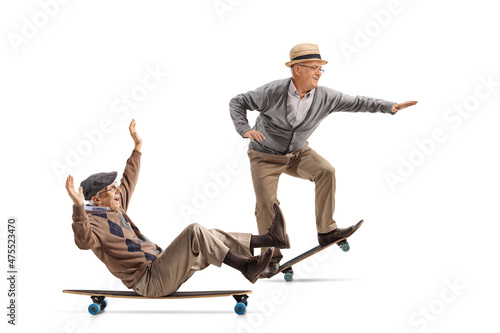 Two elderly men riding skateboards